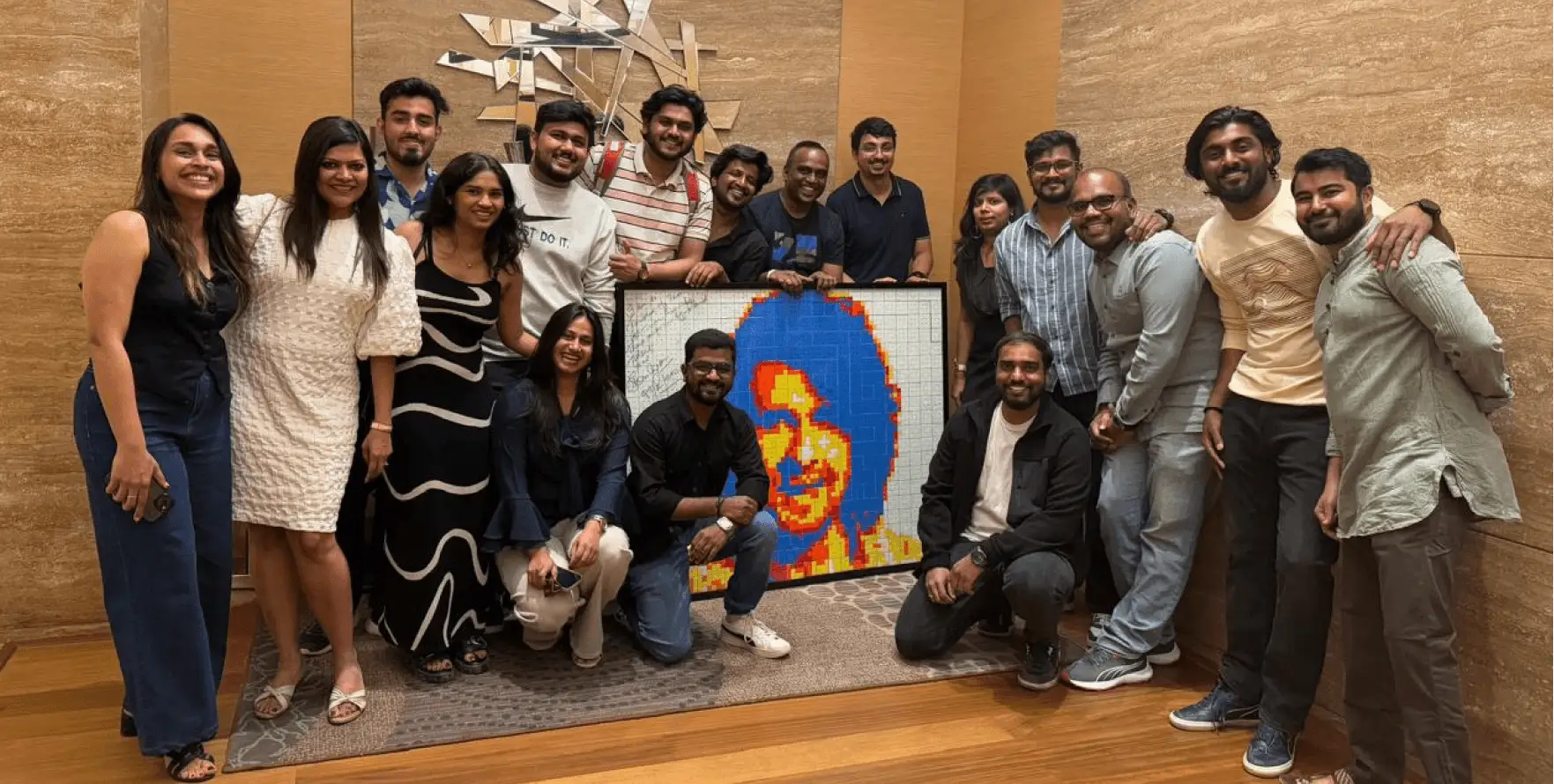 The Artium team with a mosaic portrait of Sonu Nigam made as a thank-you gift