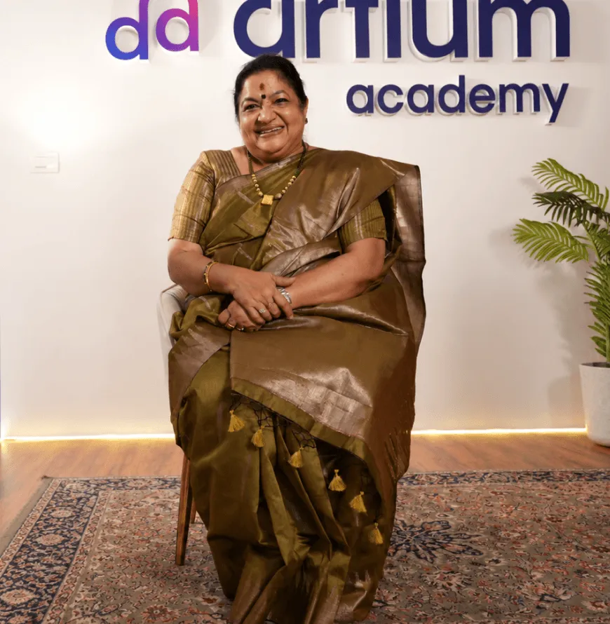 KS Chithra standing in front of the Artium sign at the office