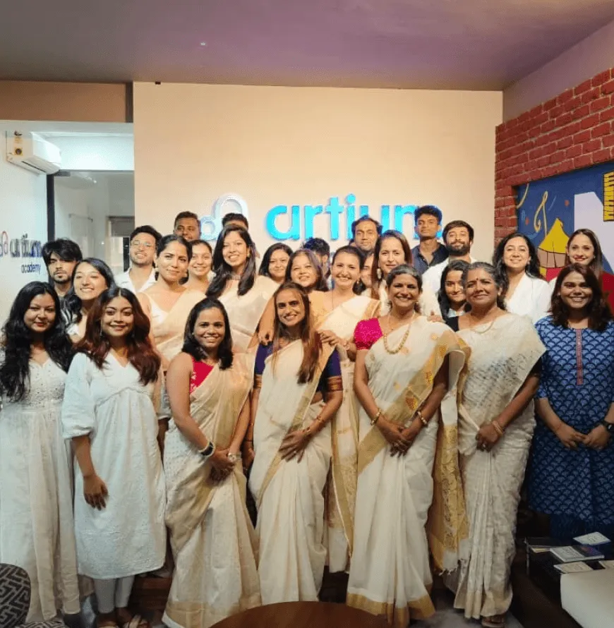 The Artium team dressed in white and gold for the Onam celebration