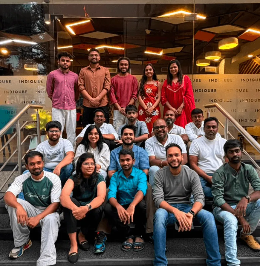 The Artium team gathered on a staircase for a group photo