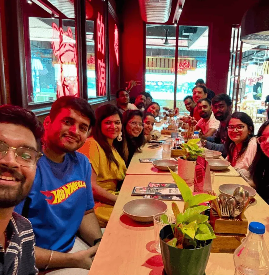 The Artium team sharing a meal at a long restaurant table