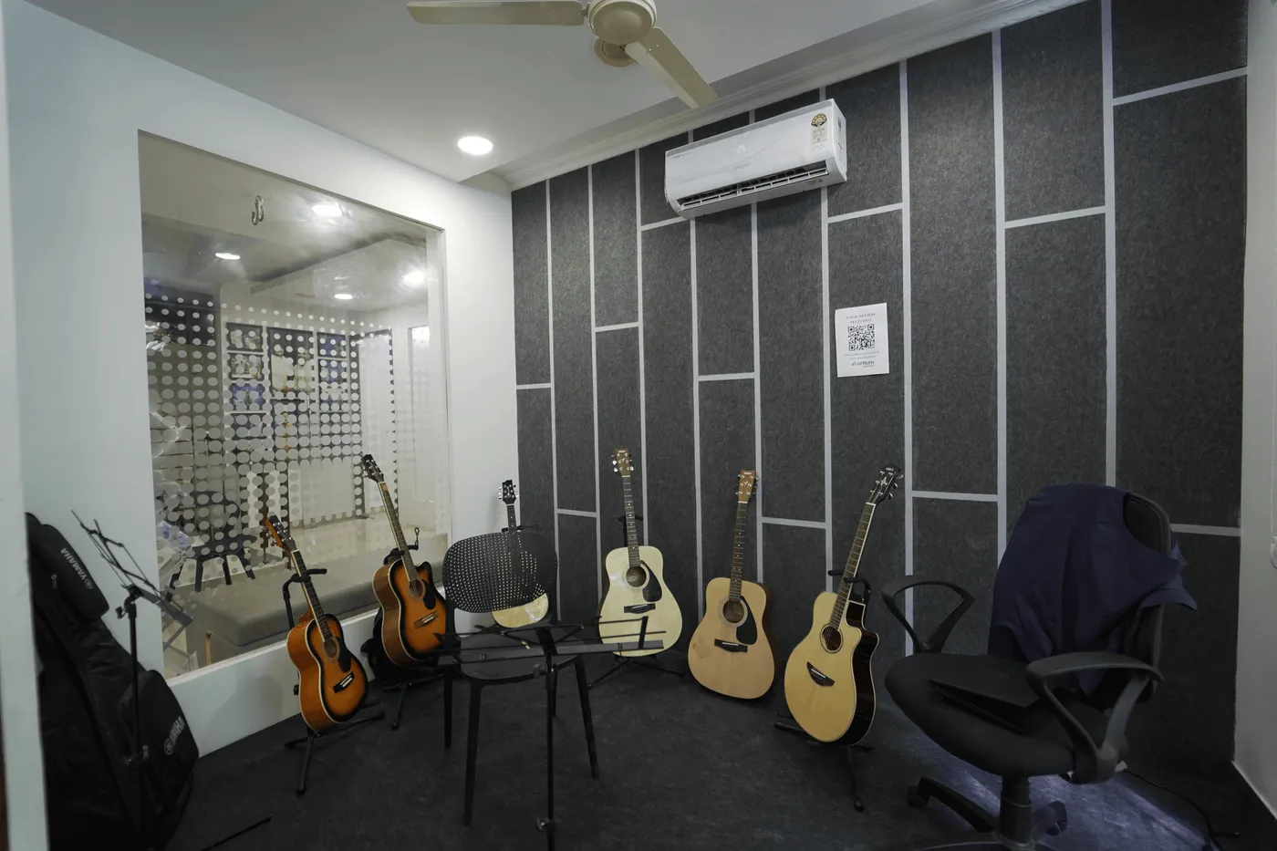 Guitars on stands in a soundproofed Artium instrument room