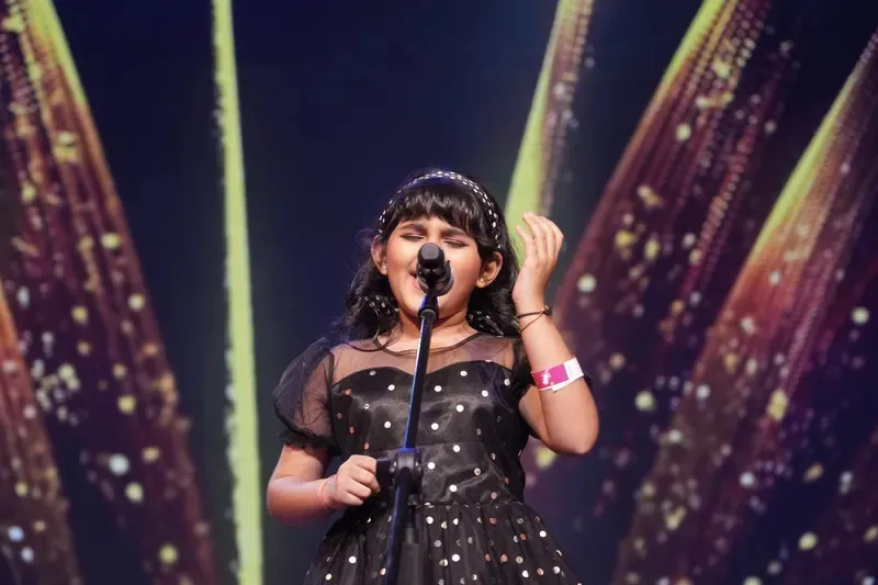 A learner performing on stage at an Artium showcase