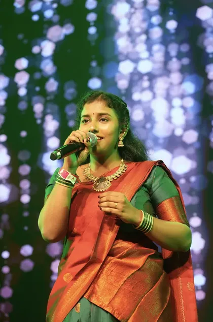 Meera Subramanian singing on stage