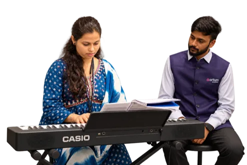 A student learning keyboard face-to-face with a teacher at an Artium Offline Centre