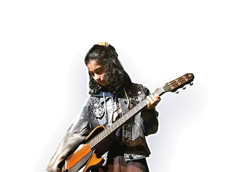 An Artium artist in a denim jacket playing the guitar