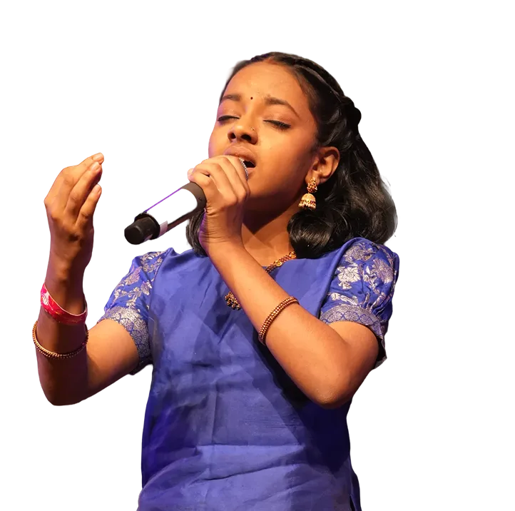 A young singer performing on stage with a microphone
