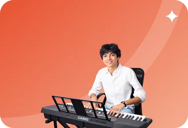 A teenage student smiling at a keyboard