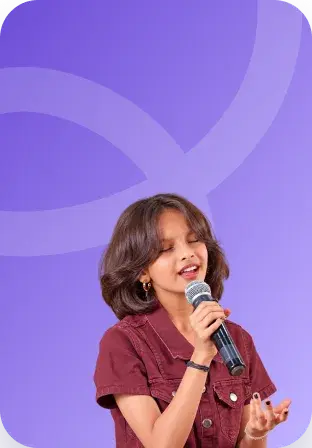 A girl singing into a handheld microphone