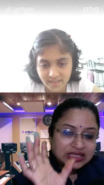 A young learner singing with her Carnatic teacher in a live class