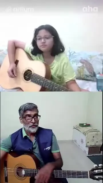 A young learner playing the guitar with her teacher in a live class