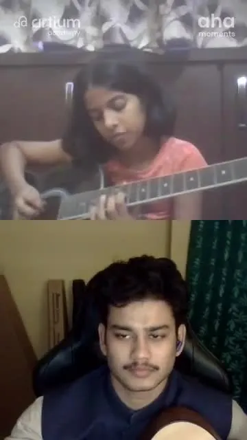 A young learner practising the guitar with her teacher in a live class