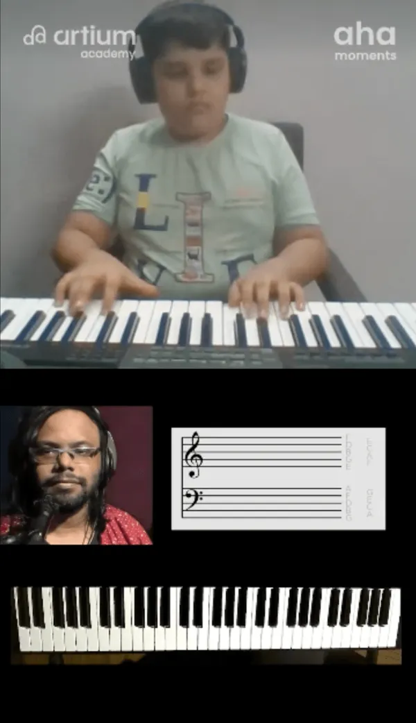 A young learner playing the keyboard with his teacher in a live Piano class
