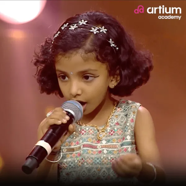 Sejal singing on a reality show stage
