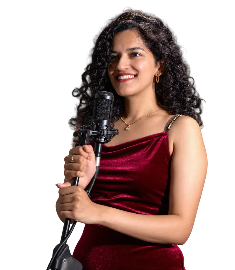An Artium artist smiling at a studio microphone