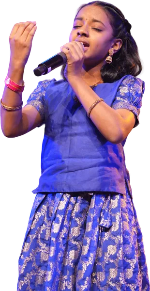 A young learner singing on the Artium Superstar stage