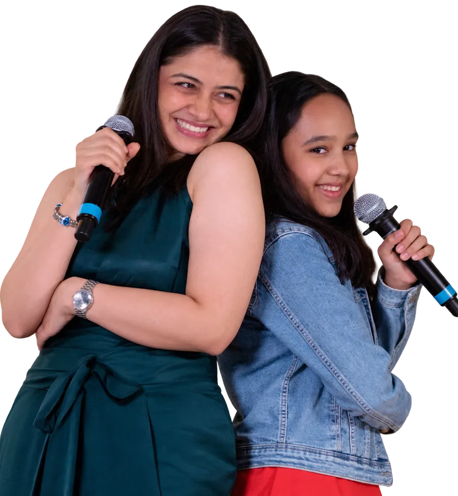 Two Artium learners, a mother and daughter, smiling back to back with microphones
