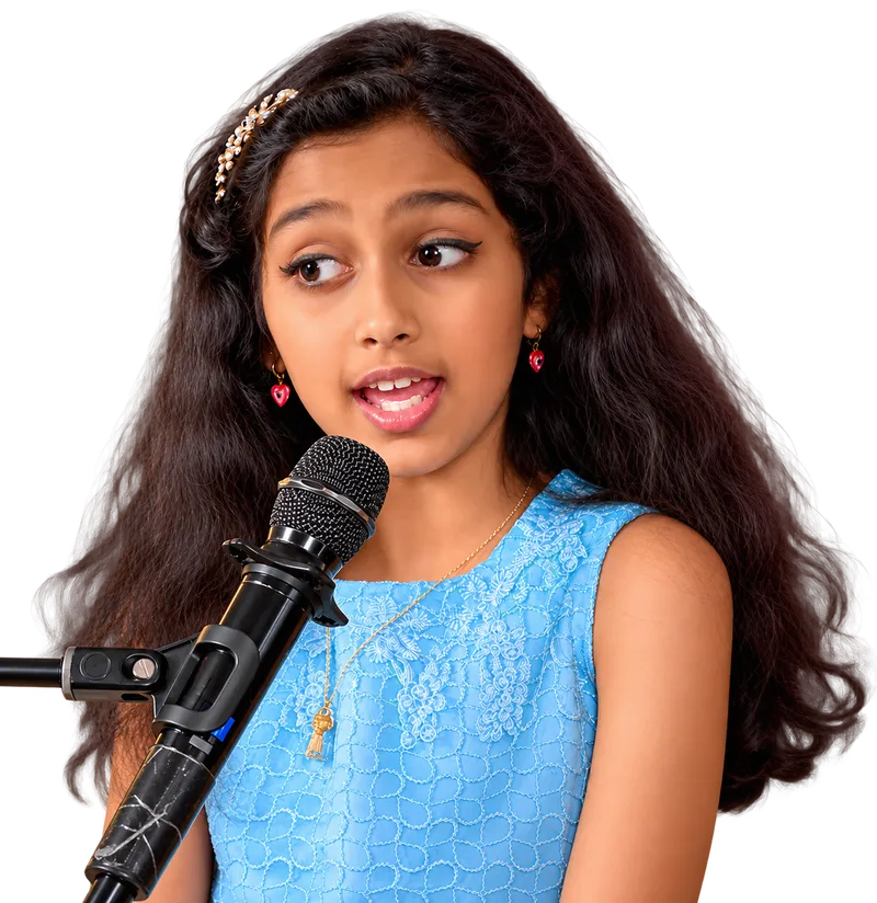 A young Artium learner singing into a microphone